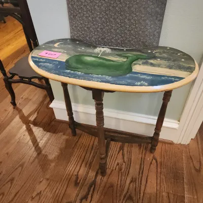 Kidney-shaped wooden accent table featuring a hand-painted scene of a green whale under a starry night sky.
