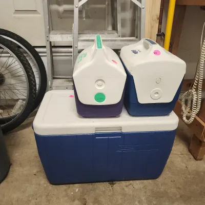 Sale Photo Thumbnail #152: Trio of vintage plastic coolers, including a large blue and white Coleman chest and two smaller Igloo personal coolers.