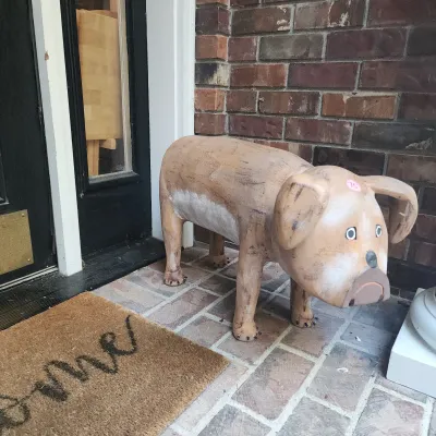 Sale Photo Thumbnail #102: Rustic carved wooden dog garden sculpture or footstool with a painted distressed finish.