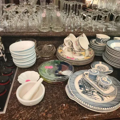 Large assortment of kitchenware and glassware including blue and white transferware dishware, fruit-patterned teacups and saucers, glass...