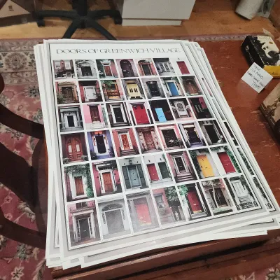 Stack of vintage "Doors of Greenwich Village" art posters featuring a photo collage of historic entryways.