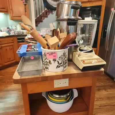 Sale Photo Thumbnail #117: Portmeirion Botanic Garden ceramic utensil crock with wooden kitchen tools, accompanied by a vintage Osterizer blender, stock pots, and Pyrex mixing bowls on a mobile kitchen island.