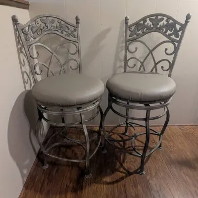 Sale Photo Thumbnail #47: Pair of metallic grey wrought iron swivel counter stools with round faux leather padded seats and ornate scrollwork backs.