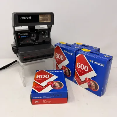 Sale Photo Thumbnail #17: Vintage Polaroid OneStep CloseUp 600 instant camera shown alongside three boxed Polaroid 600 film twin-packs.