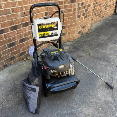 Sale Photo Thumbnail #70: Brute 2500 PSI 2.0 GPM gas-powered pressure washer with a Briggs & Stratton engine, spray wand, and owner's manual bag.