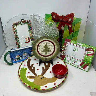 Sale Photo Thumbnail #184: Collection of festive holiday decor items, including ceramic plates, a Burton & Burton picture frame, glass sleigh bowl, and a snowman tray.