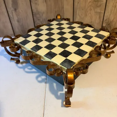 Sale Photo Thumbnail #57: Vintage pedestal chess board with an ornate gilt metal scrollwork frame and ball feet.