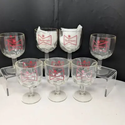 Sale Photo Thumbnail #155: Set of seven vintage Budweiser glass goblets featuring the classic red bowtie logo on clear glass.