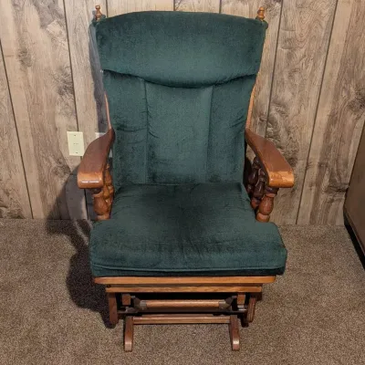 Sale Photo Thumbnail #122: Vintage oak glider rocker with dark green velvet upholstery and turned wood arm spindles.