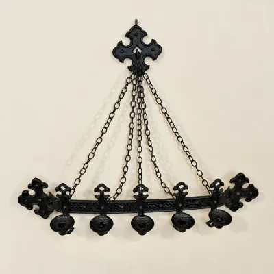 Sale Photo Thumbnail #170: Gothic Revival style black wrought iron wall-hanging candle sconce featuring a top mount and support chains for five candle holders.
