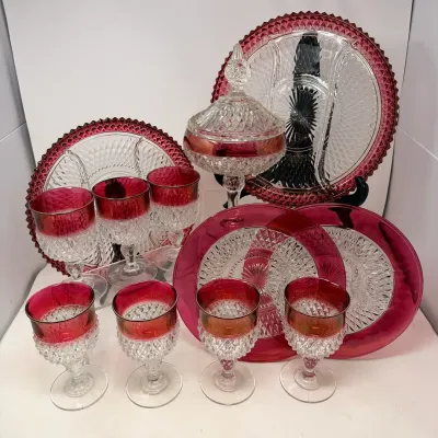 Sale Photo Thumbnail #39: Collection of vintage ruby flashed press glass dishware, including stemware goblets, plates, divided serving trays, and a covered candy dish in a diamond point pattern.