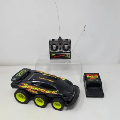 Sale Photo Thumbnail #152: Vintage 1990s Tyco R/C Scorcher 6x6 radio-controlled vehicle with original remote transmitter and battery charger.