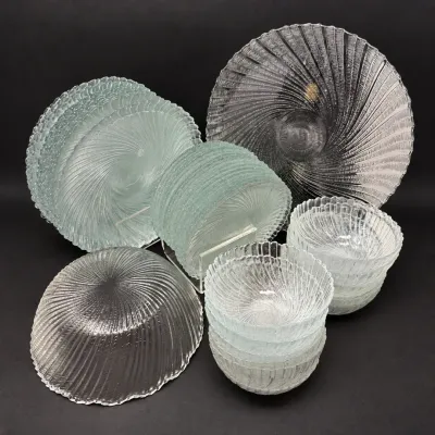 Sale Photo Thumbnail #38: Collection of mid-century clear glass tableware featuring swirl patterns, including plates, small bowls, and large serving pieces.