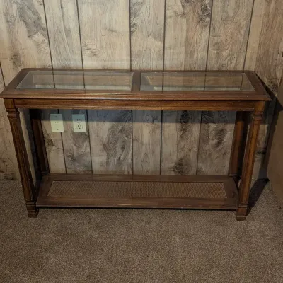 Sale Photo Thumbnail #53: Traditional dark wood console table featuring two glass-insert panel tops and a cane lower display shelf.
