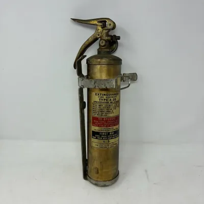 Sale Photo Thumbnail #166: Vintage brass aircraft fire extinguisher, Type A-20, manufactured by The Fyr-Fyter Company with original mounting bracket and labeled instructions.