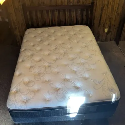 Sale Photo Thumbnail #43: Queen-size pillow-top mattress and box spring set paired with a dark wood slatted headboard.