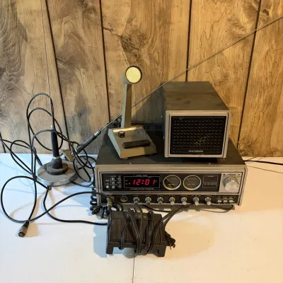 Sale Photo Thumbnail #143: Vintage Uniden Madison 40-channel AM/SSB CB base station radio with matching speaker, desktop microphone, and attached antennas.