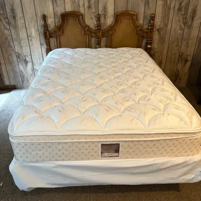 Sale Photo Thumbnail #132: DreamHaven pillowtop mattress set on a vintage wooden headboard with woven cane inset panels.