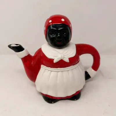 Sale Photo Thumbnail #30: Vintage ceramic Mammy teapot featuring a red dress, white apron, and red polka-dot headscarf.