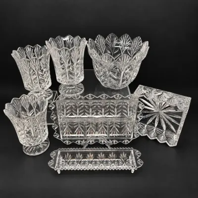 Sale Photo Thumbnail #35: Seven-piece collection of matching cut lead crystal glassware, including footed vases, a bowl, and serving dishes featuring leaf and starburst motifs.