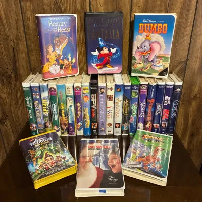 Sale Photo Thumbnail #187: Large collection of vintage family and children's VHS tapes, including Disney Classics clamshell cases such as Beauty and the Beast, Fantasia, and Dumbo.