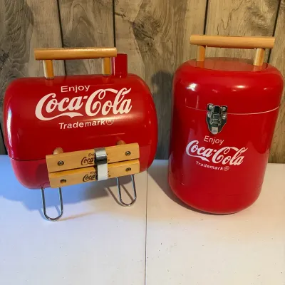 Sale Photo Thumbnail #60: Pair of vintage-style red Coca-Cola tabletop grills with wooden handles and metal latches.