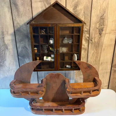Sale Photo Thumbnail #144: Vintage wooden house-shaped shadow box filled with miniature collectibles, positioned behind a rustic wooden crescent moon wall shelf with small railings.
