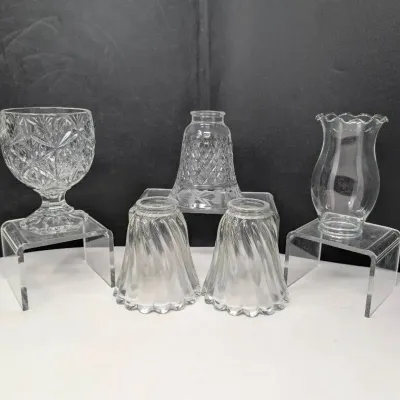 Sale Photo Thumbnail #97: Collection of five clear pressed glass lamp shades and hurricane globes in various cut and swirl patterns.