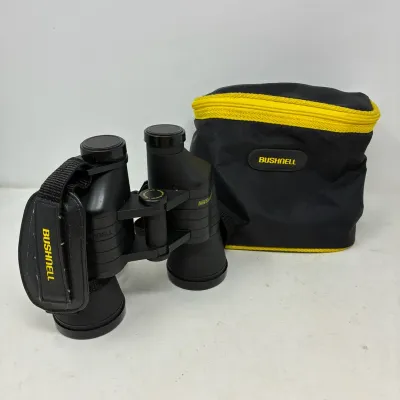 Sale Photo Thumbnail #173: Bushnell Insta-Focus black binoculars with lens caps, attached hand strap, and matching zippered soft carrying case.