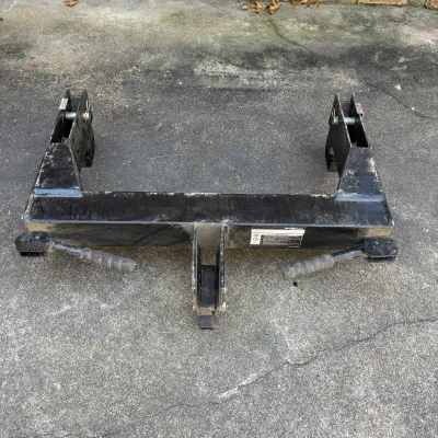 Sale Photo Thumbnail #71: Roadmaster Quick-Hitch tow bar adapter in heavy-duty black painted steel, showing light surface wear and dirt from previous use.
