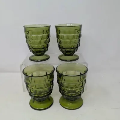 Sale Photo Thumbnail #153: Set of four vintage olive green footed glassware tumblers featuring a textured, geometric panel design.
