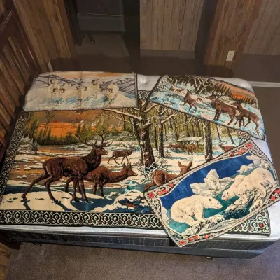 Sale Photo Thumbnail #48: Collection of vintage woven wildlife wall tapestries, featuring designs with deer, polar bears, and bighorn sheep.