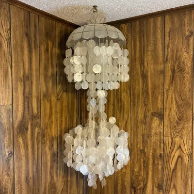 Sale Photo Thumbnail #185: Vintage mid-century Capiz shell cascading chandelier swag lamp, hanging from a ceiling hook.