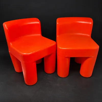 Sale Photo Thumbnail #177: Pair of bright orange molded plastic children's chairs featuring a chunky, modern low-profile design.