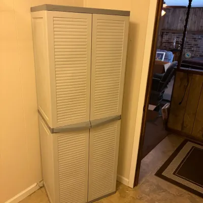 Sale Photo Thumbnail #65: Tall off-white plastic utility storage cabinet featuring shutter-style doors with grey trim.