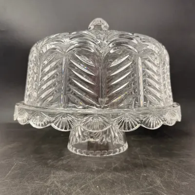 Sale Photo Thumbnail #31: Vintage pressed clear glass pedestal cake stand featuring an ornate feather or palm motif and matching cloche dome.