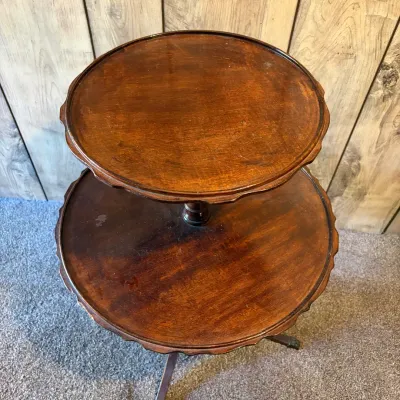 Sale Photo Thumbnail #63: Vintage dark stain wooden two-tier dumbbell side table with scalloped piecrust edges and a tripod base.