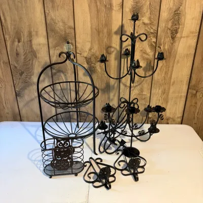 Sale Photo Thumbnail #61: Collection of black wrought iron home accents, including candelabras, wall sconces, a two-tiered wire basket stand, and an owl motif holder.