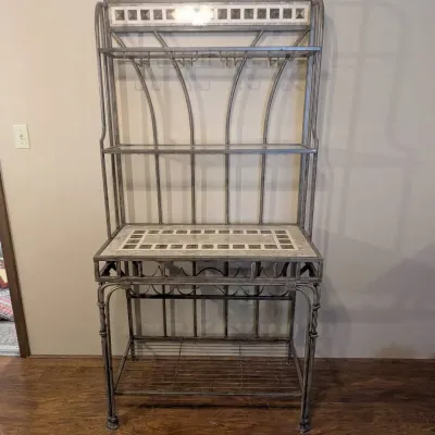 Sale Photo Thumbnail #46: Metal baker's rack featuring faux marble and tile inlay details, glass upper shelves, integrated wine glass stemware holders, and a wine bottle rack below.