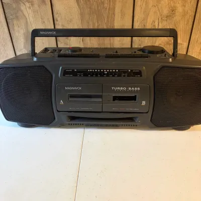 Sale Photo Thumbnail #147: Vintage Magnavox Turbo Bass Generator dual cassette boombox with AM/FM radio and carrying handle.
