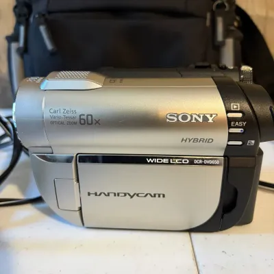 Sale Photo Thumbnail #130: Sony Handycam DCR-DVD650 Hybrid camcorder with Carl Zeiss Vario-Tessar 60x optical zoom lens, featuring a flip-out wide LCD screen.