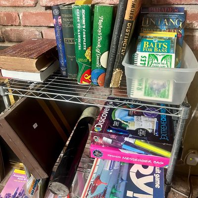 Sale Photo Thumbnail #54: Wire utility shelf organized with vintage books, including Playboy's Book of Games, alongside board games like Parker Brothers Sorry! and various activity kits.