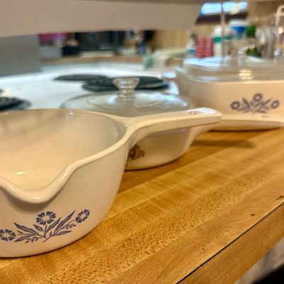 Sale Photo Thumbnail #64: Vintage CorningWare Cornflower Blue pattern casserole dishes and a pouring saucepan with clear glass lids.