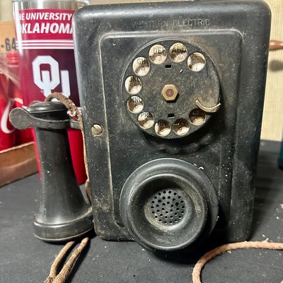 Sale Photo Thumbnail #66: Vintage Western Electric metal wall phone with a rotary dial and separate earpiece receiver.