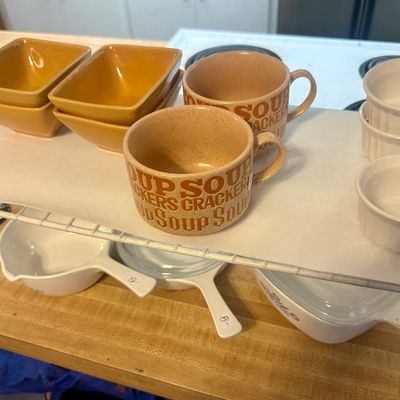 Sale Photo Thumbnail #63: Collection of vintage kitchenware including retro ceramic soup and cracker mugs, yellow square bowls, white ramekins, and Pyrex cookware.