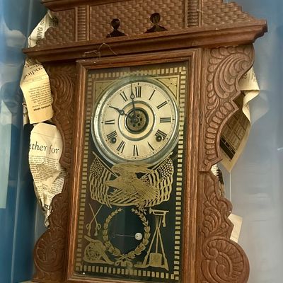 Sale Photo Thumbnail #42: Antique carved wooden gingerbread wall clock featuring patriotic eagle and flag graphics on the lower glass door panel.