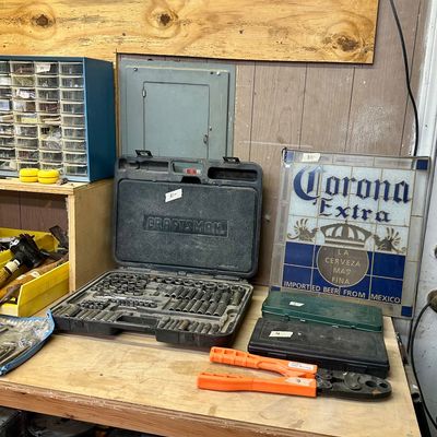 Sale Photo Thumbnail #8: Craftsman socket set in a black blow-molded case alongside orange bolt cutters, small tool cases, and a framed Corona Extra stained glass-style sign.