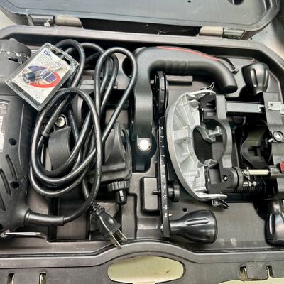 Sale Photo Thumbnail #6: Dremel rotary tool set with various attachments and accessories in a black plastic molded carrying case.