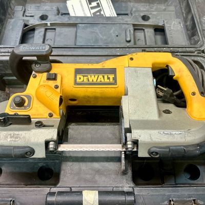 Sale Photo Thumbnail #5: DeWalt corded portable band saw in yellow and gray, housed inside its original black hard plastic carrying case.
