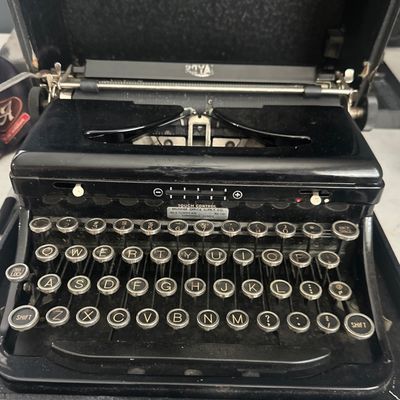 Sale Photo Thumbnail #69: Vintage Royal portable manual typewriter with round glass keys, housed in its original black carrying case.